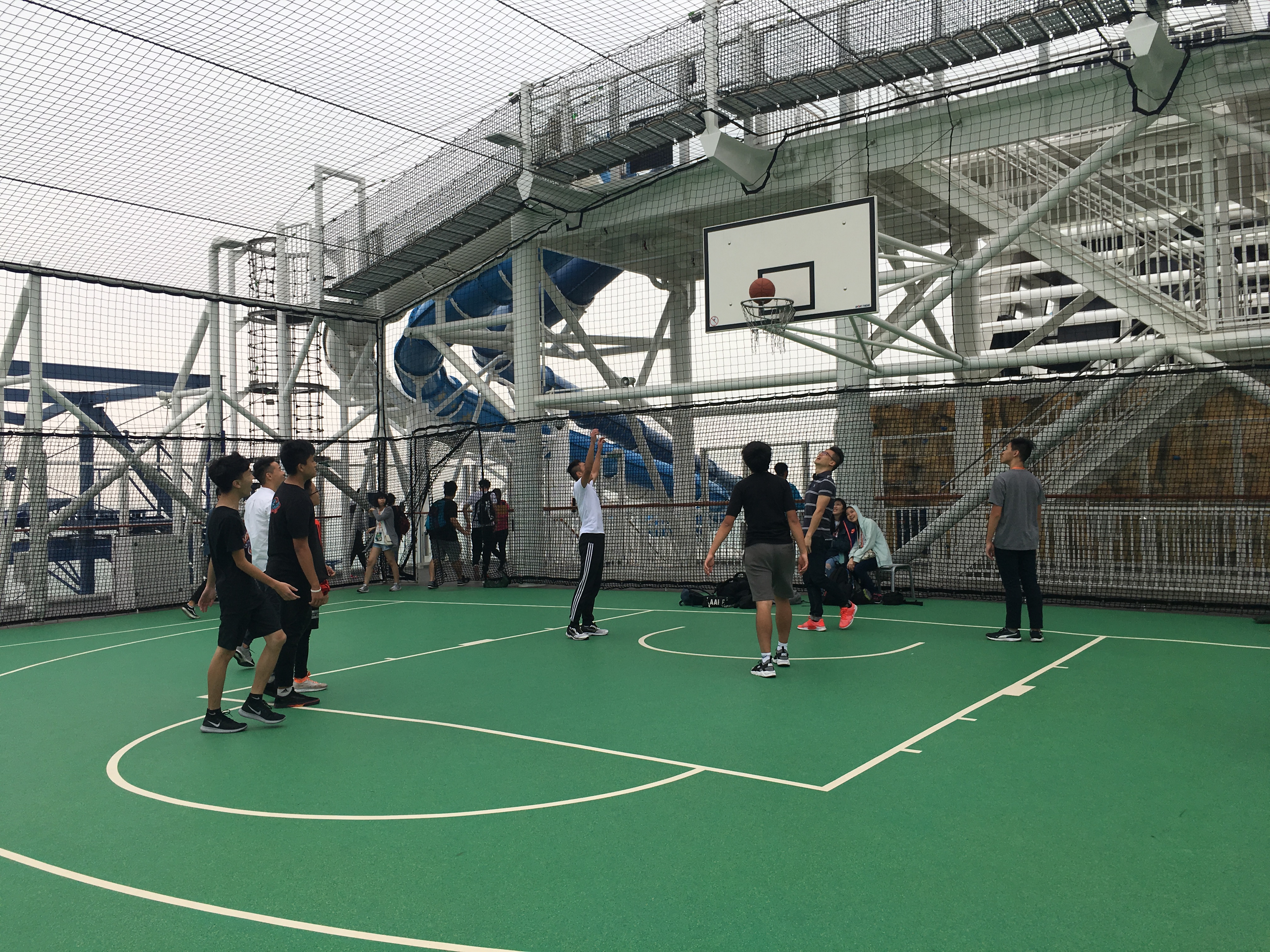 Participants showing their sports talents at the basketball court on the roof deck of the cruise. 