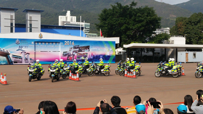 Motorcycle riders of the Force Escort Group showing superb driving skills by manoeuvring around traffic cones.