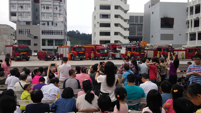 Visitors capturing the fire appliance and ambulance parade with cameras.  