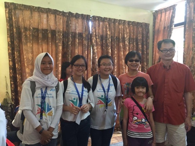 Jenny (third left) and her host family in Malaysia.