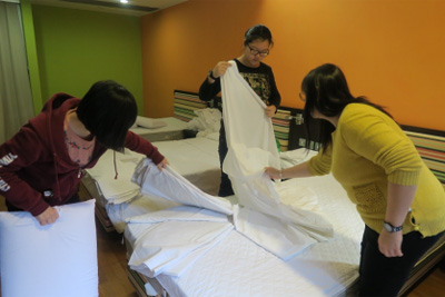Participants gaining hands-on experience in room preparation.