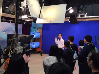 Participants at the HKO TV studio learning how weather forecast clips are made and transmitted to TV stations for broadcasting.
